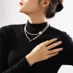 Freshwater Pearl & Gold Necklace 5 LIVKE’s irregular freshwater pearl necklace on a gold chain, styled with a beige sweater for minimalist everyday elegance.