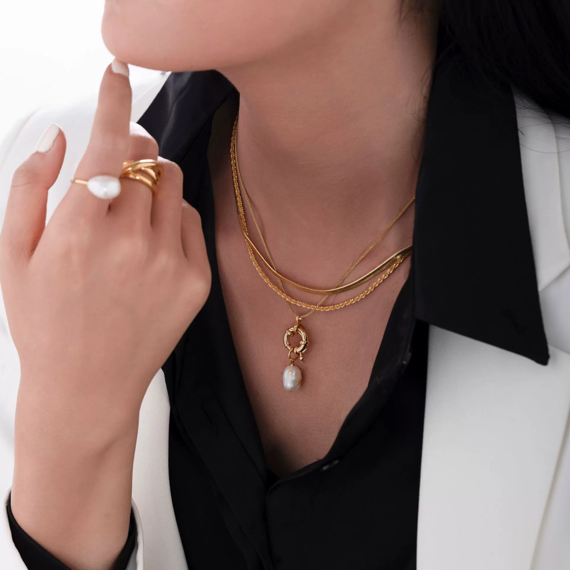 English: “Close-up of LIVKE’s 18K gold plated oval bead necklace in vintage palace style, styled elegantly on a model.”