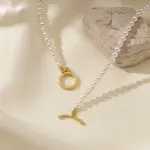 Freshwater Pearl & Gold Necklace 4 LIVKE’s irregular freshwater pearl necklace on a gold chain, styled with a beige sweater for minimalist everyday elegance.