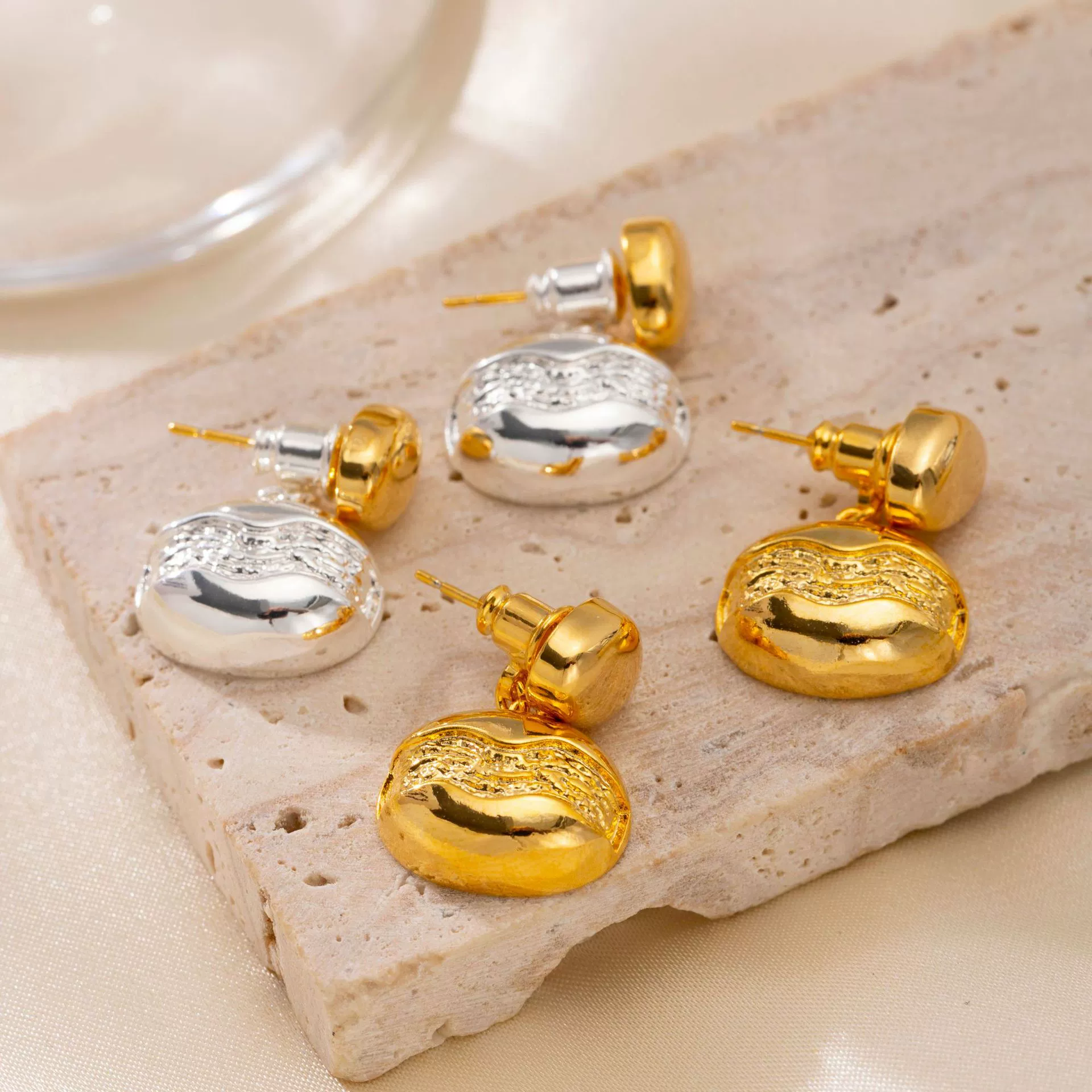 brass-gold-plated-stud-earrings.jpg Close-up of brass gold-plated stud earrings showcasing elegant minimalist design.