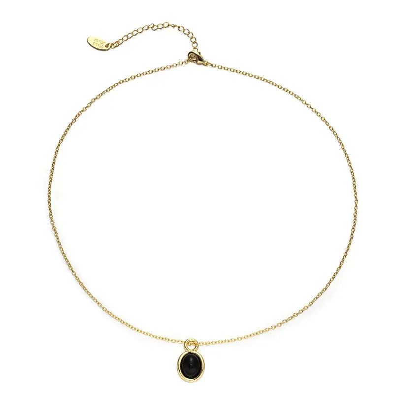 LIVKE’s gold-plated agate heart necklace styled with black silk dress for timeless minimalist elegance