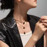 LIVKE’s gold-plated agate heart necklace styled with black silk dress for timeless minimalist elegance