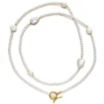 Freshwater Pearl & Gold Necklace 1 LIVKE’s irregular freshwater pearl necklace on a gold chain, styled with a beige sweater for minimalist everyday elegance.