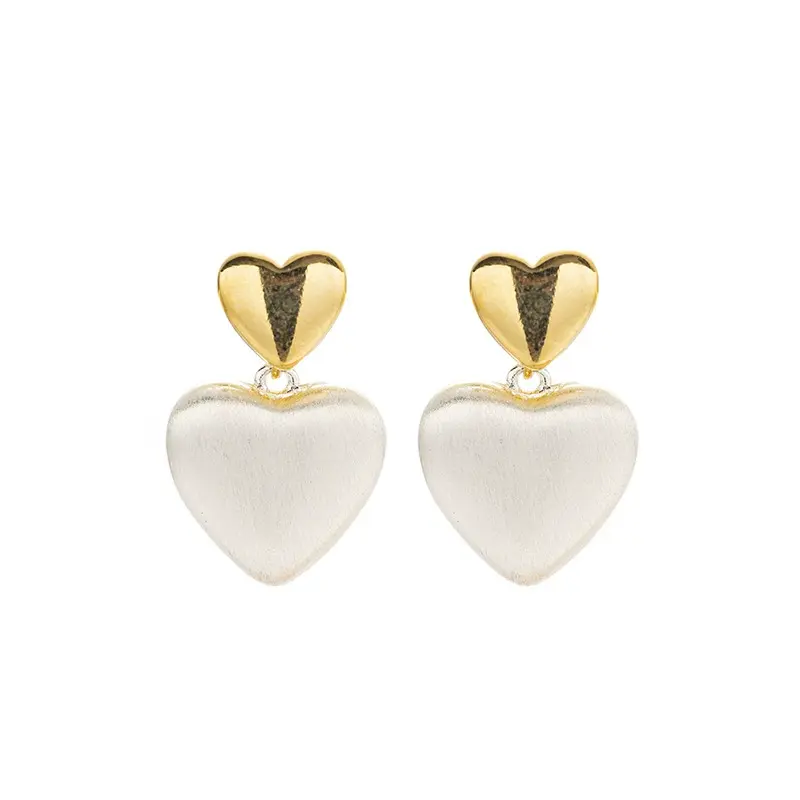 LIVKE’s vintage heart stud earrings with textured gold finish, styled with a denim jacket for casual-chic outfits.
