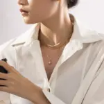 LIVKE’s vintage genuine pearl necklace with 18K gold-plated chain, styled with a black silk dress for timeless elegance.