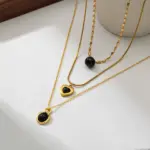 LIVKE’s gold-plated agate heart necklace styled with black silk dress for timeless minimalist elegance