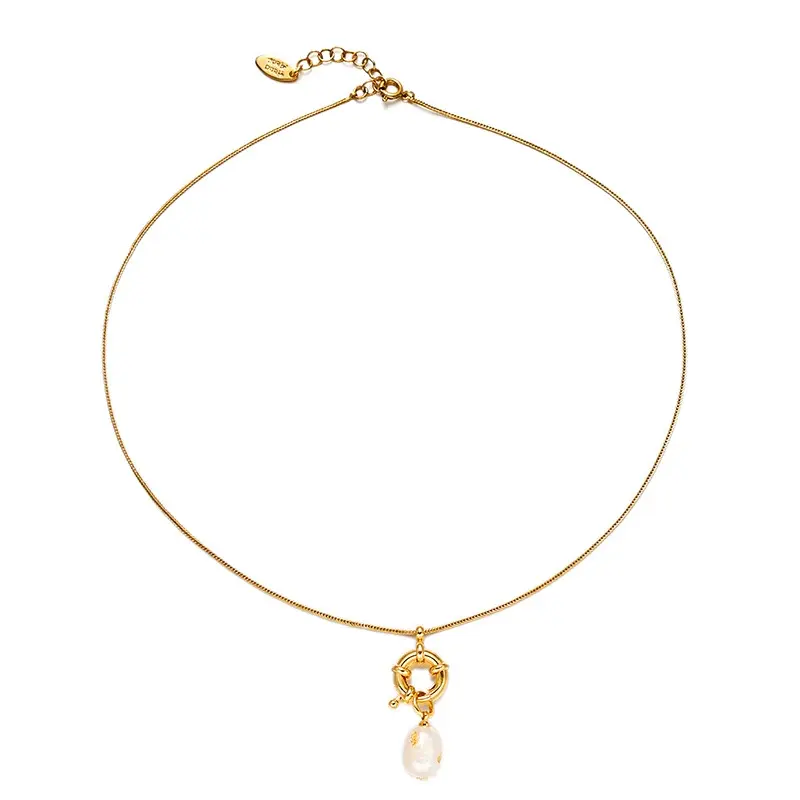 English: “Close-up of LIVKE’s 18K gold plated oval bead necklace in vintage palace style, styled elegantly on a model.”