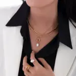 Vintage Brass Pearl Necklace 2 English: “Close-up of LIVKE’s 18K gold plated oval bead necklace in vintage palace style, styled elegantly on a model.”