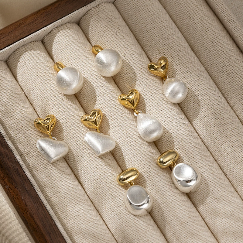 LIVKE’s vintage heart stud earrings with textured gold finish, styled with a denim jacket for casual-chic outfits.