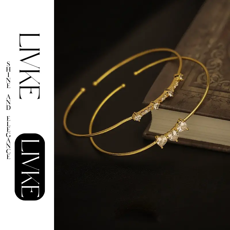 LIVKE’s gold open cuff bracelet with cubic zirconia, styled with a white shirt and watch for modern minimalist elegance.