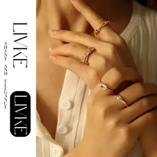 LIVKE’s gold open ring with cubic zirconia, stacked with silver bands for urban minimalist style.