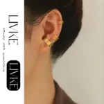 LIVKE’s gold openwork ear cuff styled on a helix, paired with minimalist hoops for edgy everyday elegance.