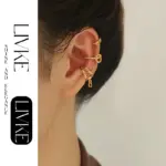 LIVKE’s gold openwork ear cuff styled on a helix, paired with minimalist hoops for edgy everyday elegance.