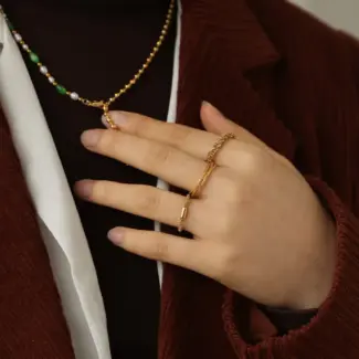 LIVKE’s 18K PVD gold minimalist ring stacked with raw-edge bands for modern gender-neutral style.