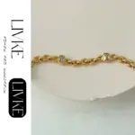 18K Gold-Plated Cubic Zirconia Watch Band Bracelet 5 LIVKE’s gold watch band bracelet with geometric zirconia links, styled with a leather folio for modern power dressing.