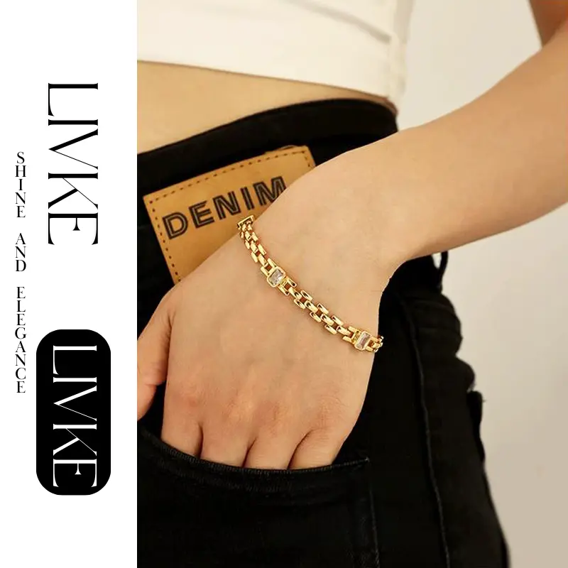 LIVKE’s gold watch band bracelet with geometric zirconia links, styled with a leather folio for modern power dressing.
