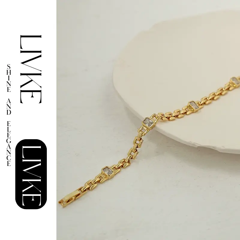 LIVKE’s gold watch band bracelet with geometric zirconia links, styled with a leather folio for modern power dressing.