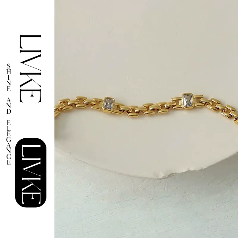 LIVKE’s gold watch band bracelet with geometric zirconia links, styled with a leather folio for modern power dressing.
