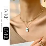 Boho Shell & Turquoise Pendant Necklace 2 LIVKE’s gold snake chain necklace with shell and turquoise pendant, layered with beaded bracelets for boho summer style.