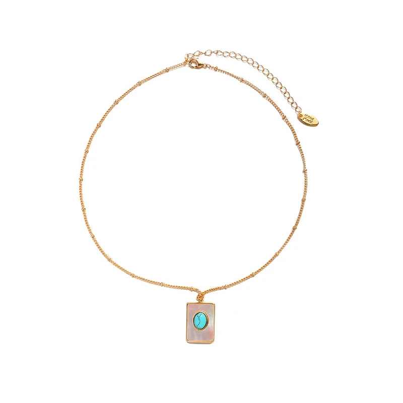 livke-boho-shell-turquoise-necklace (4) LIVKE’s gold snake chain necklace with shell and turquoise pendant, layered with beaded bracelets for boho summer style.