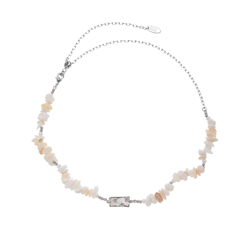 LIVKE’s single-strand boho beach necklace with shells and gold accents, styled with a white tank top for minimalist coastal style.