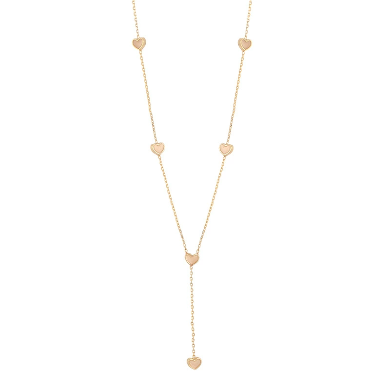 LIVKE’s gold enamel heart pendant necklace styled with a floral dress for Parisian-inspired everyday charm.