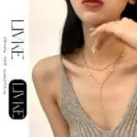 French-Inspired Enamel Heart Necklace 2 LIVKE’s gold enamel heart pendant necklace styled with a floral dress for Parisian-inspired everyday charm.