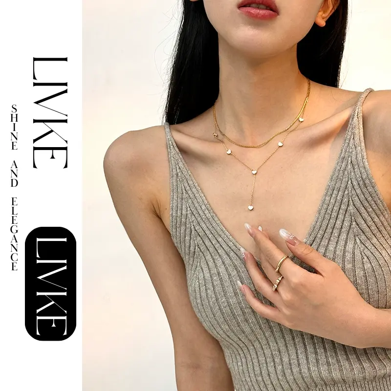 LIVKE’s gold enamel heart pendant necklace styled with a floral dress for Parisian-inspired everyday charm.