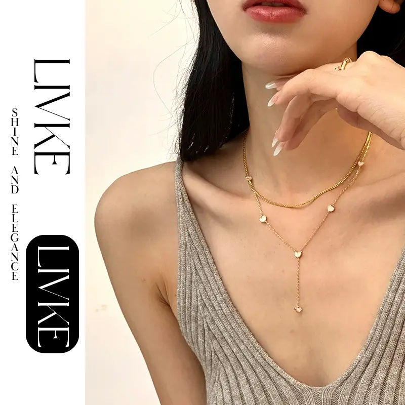 LIVKE’s gold enamel heart pendant necklace styled with a floral dress for Parisian-inspired everyday charm.