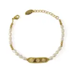 French Elegance Pearl Bracelet 1 LIVKE’s French pearl bracelet with gold and zirconia accents, styled with a striped Breton top for effortless Parisian elegance.