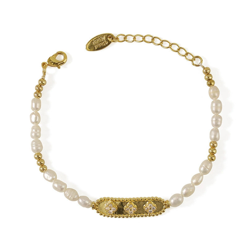 LIVKE’s French pearl bracelet with gold and zirconia accents, styled with a striped Breton top for effortless Parisian elegance.