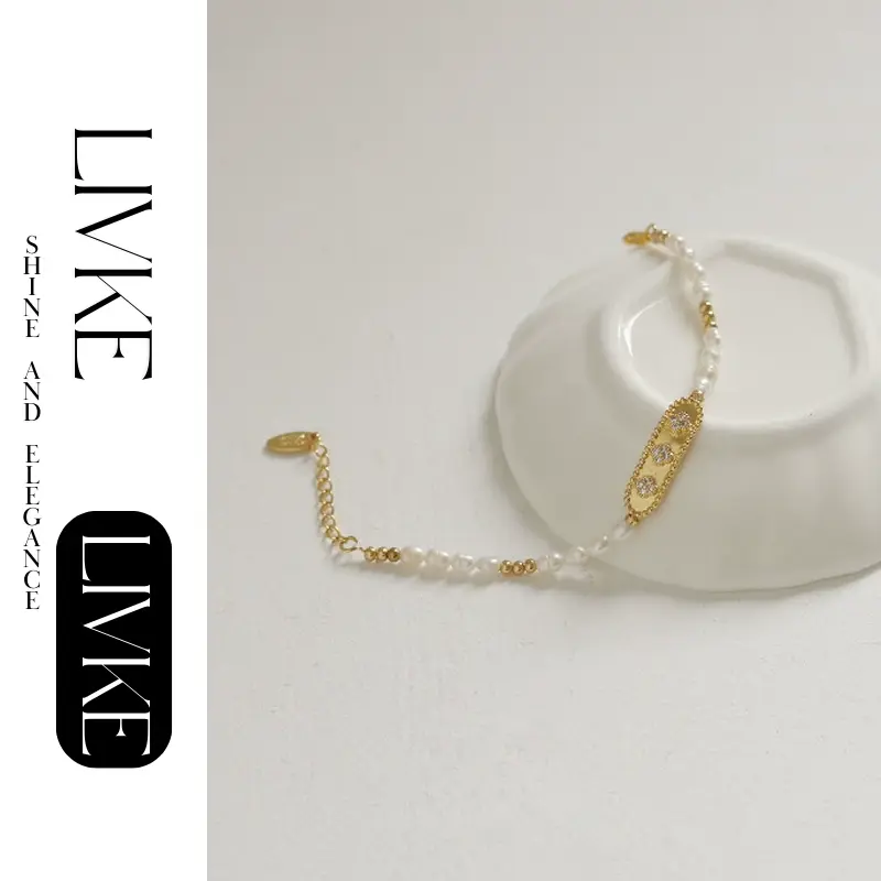 LIVKE’s French pearl bracelet with gold and zirconia accents, styled with a striped Breton top for effortless Parisian elegance.