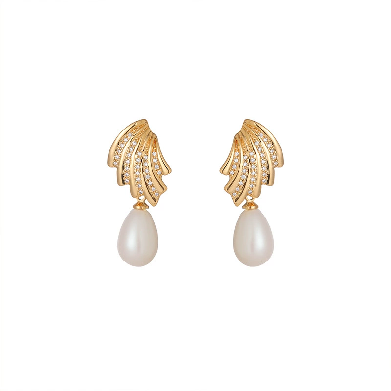 livke-french-vintage-pearl-zirconia-earrings LIVKE’s gold vintage pearl drop earrings with zirconia accents, styled with a black dress for Parisian evening elegance.