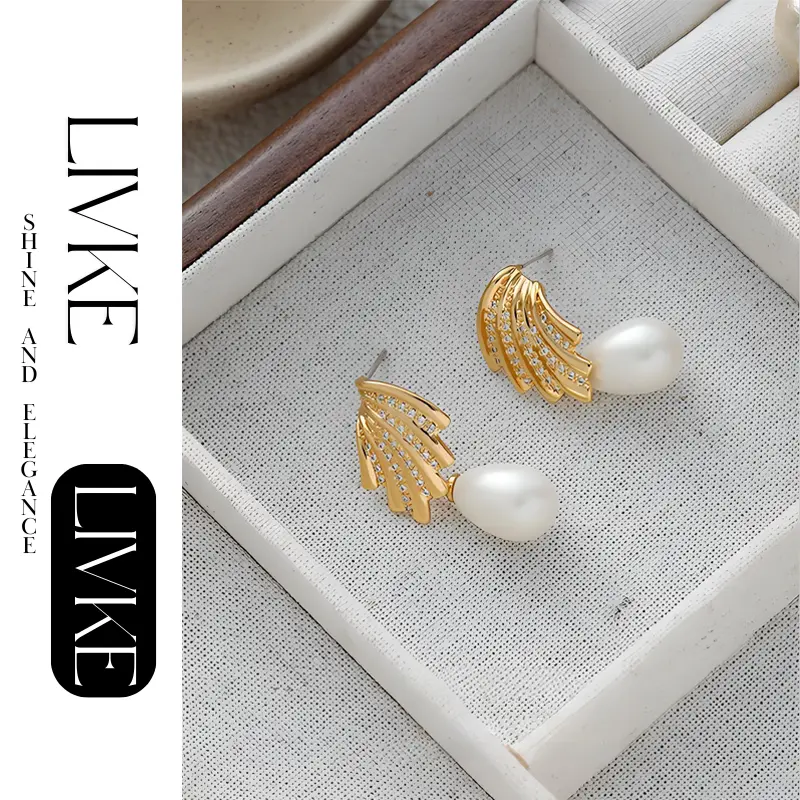 livke-french-vintage-pearl-zirconia-earrings (3) LIVKE’s gold vintage pearl drop earrings with zirconia accents, styled with a black dress for Parisian evening elegance.