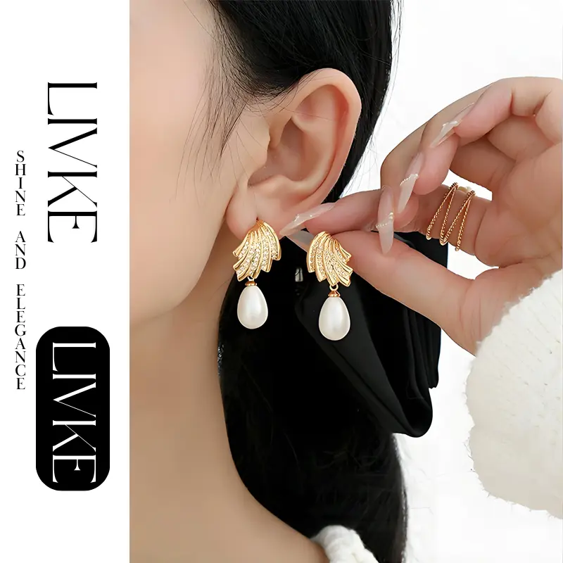 livke-french-vintage-pearl-zirconia-earrings LIVKE’s gold vintage pearl drop earrings with zirconia accents, styled with a black dress for Parisian evening elegance.