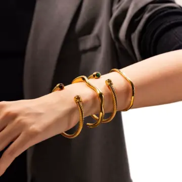 LIVKE’s minimalist gold adjustable bangle bracelet styled with a white button-up for office elegance.