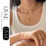 Layered 3D Heart Necklace Set 4 LIVKE’s gold layered heart necklaces styled with a black turtleneck for minimalist everyday elegance.