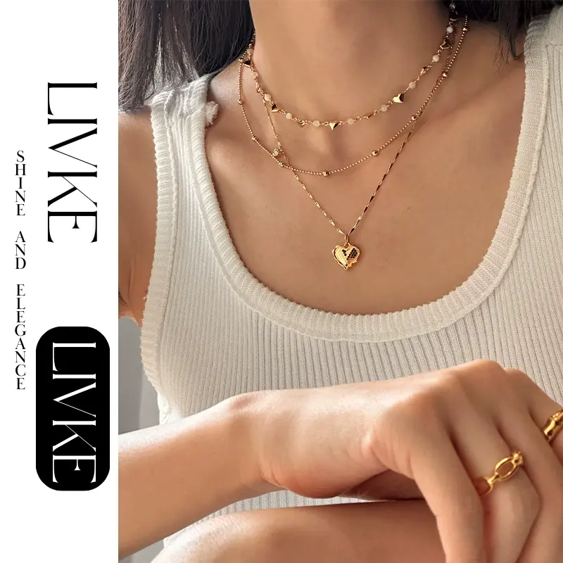 livke-layered-heart-shell-necklace-set (2) LIVKE’s gold layered heart necklaces styled with a black turtleneck for minimalist everyday elegance.