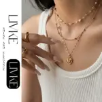 Layered 3D Heart Necklace Set 2 LIVKE’s gold layered heart necklaces styled with a black turtleneck for minimalist everyday elegance.