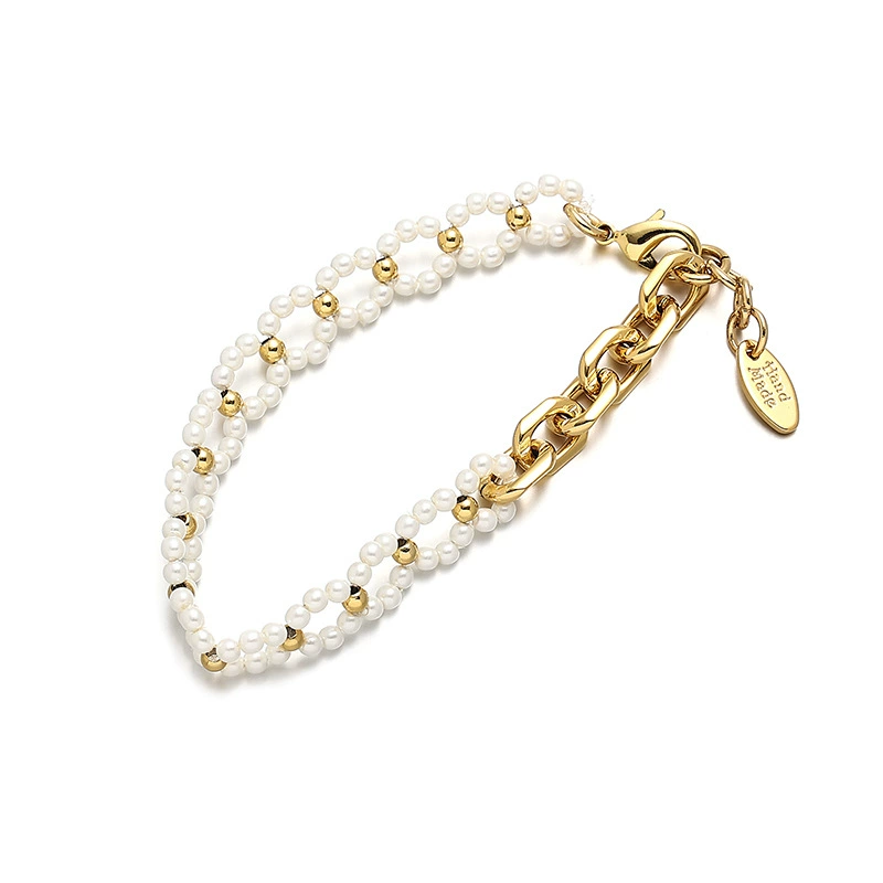 LIVKE’s gold pearl chain bracelet styled on a wrist with a linen sleeve for boho everyday elegance.