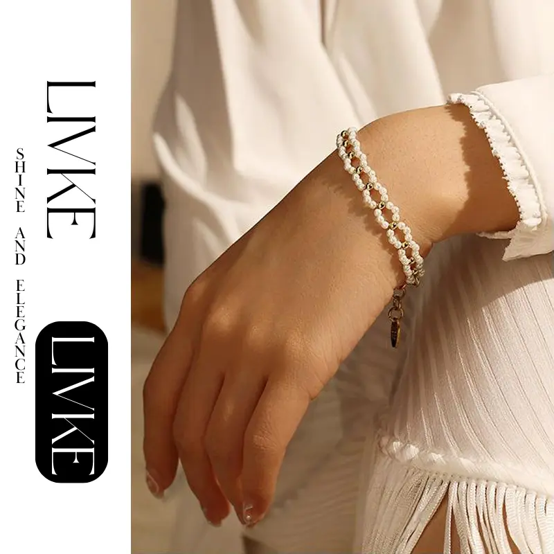 LIVKE’s gold pearl chain bracelet styled on a wrist with a linen sleeve for boho everyday elegance.