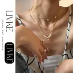 Layered Freshwater Pearl & Shell Necklace Set 3 LIVKE’s layered pearl and shell necklaces styled with a white sundress and straw bag for beach-to-bar elegance.
