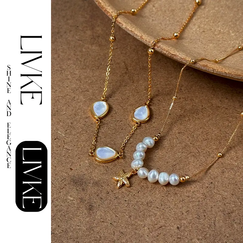 LIVKE’s layered pearl and shell necklaces styled with a white sundress and straw bag for beach-to-bar elegance.