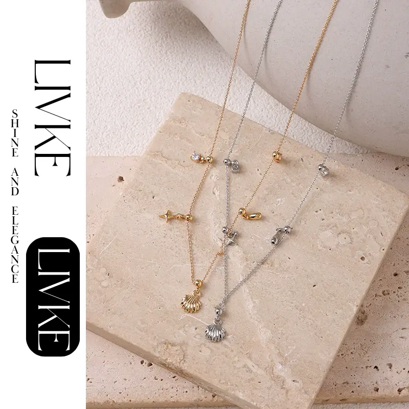 LIVKE’s gold summer wave necklace with shell and zirconia pendant, styled with a straw hat for beachside elegance.