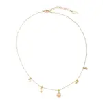 Summer Wave Necklace 1 LIVKE’s gold summer wave necklace with shell and zirconia pendant, styled with a straw hat for beachside elegance.