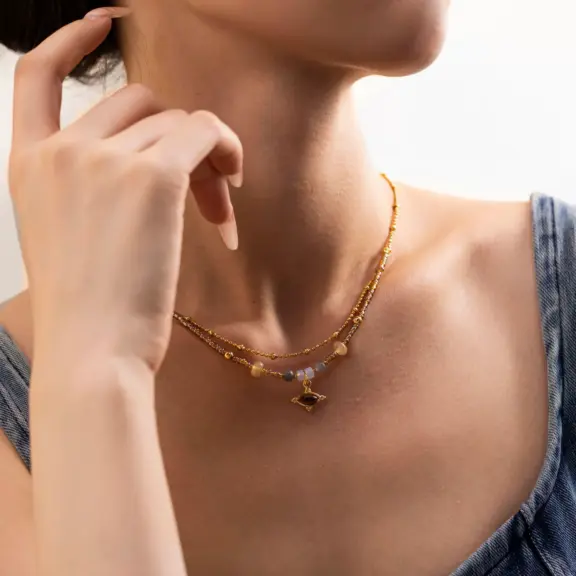 LIVKE’s tiger eye bead necklace with gold and zirconia accents, styled with a linen dress for boho everyday elegance.