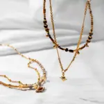 Tiger Eye Bead Necklace 4 LIVKE’s tiger eye bead necklace with gold and zirconia accents, styled with a linen dress for boho everyday elegance.