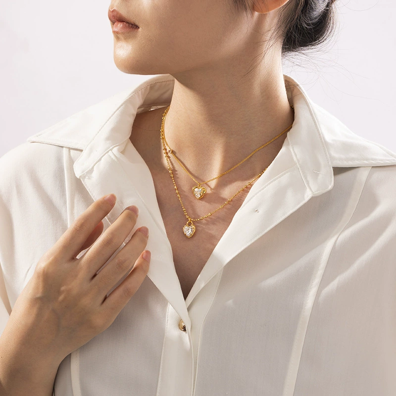 LIVKE’s gold vintage heart necklace with cubic zirconia, layered with a thin chain for minimalist office elegance.