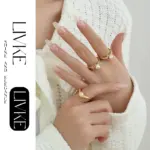 Vintage Gold Leaf Pearl Ring 3 LIVKE’s gold leaf and pearl adjustable ring on a hand with neutral nails, styled with a linen dress for effortless boho elegance.