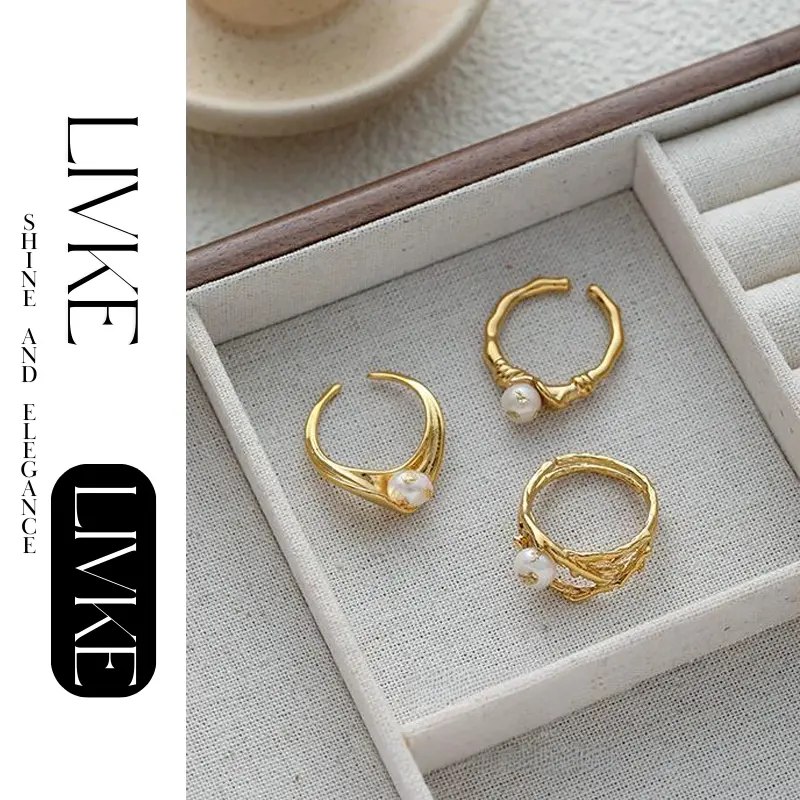 livke-vintage-pearl-gold-leaf-ring (3) LIVKE’s gold leaf and pearl adjustable ring on a hand with neutral nails, styled with a linen dress for effortless boho elegance.